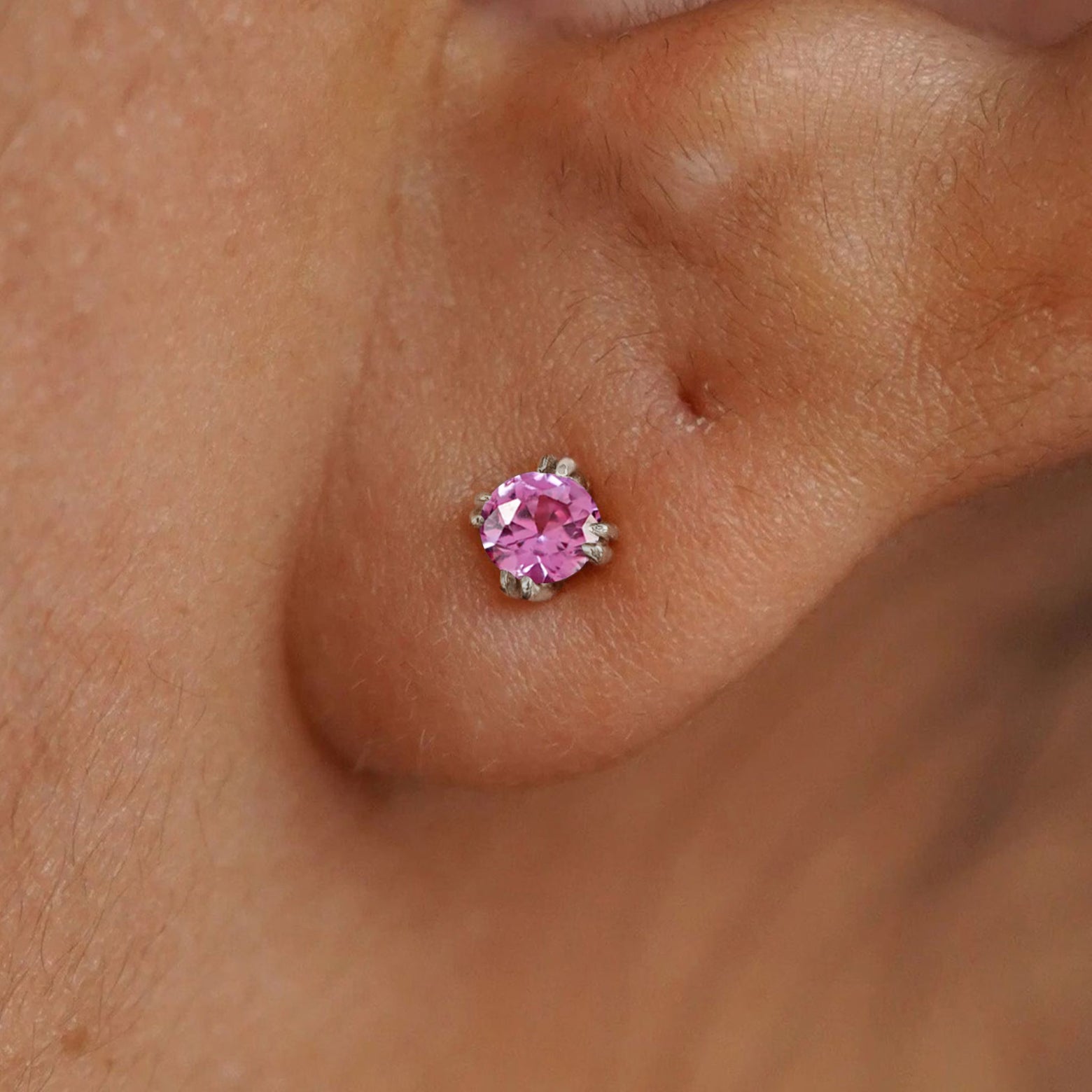 Close up view of a model's ear wearing a 14k white gold Onyx Earring
