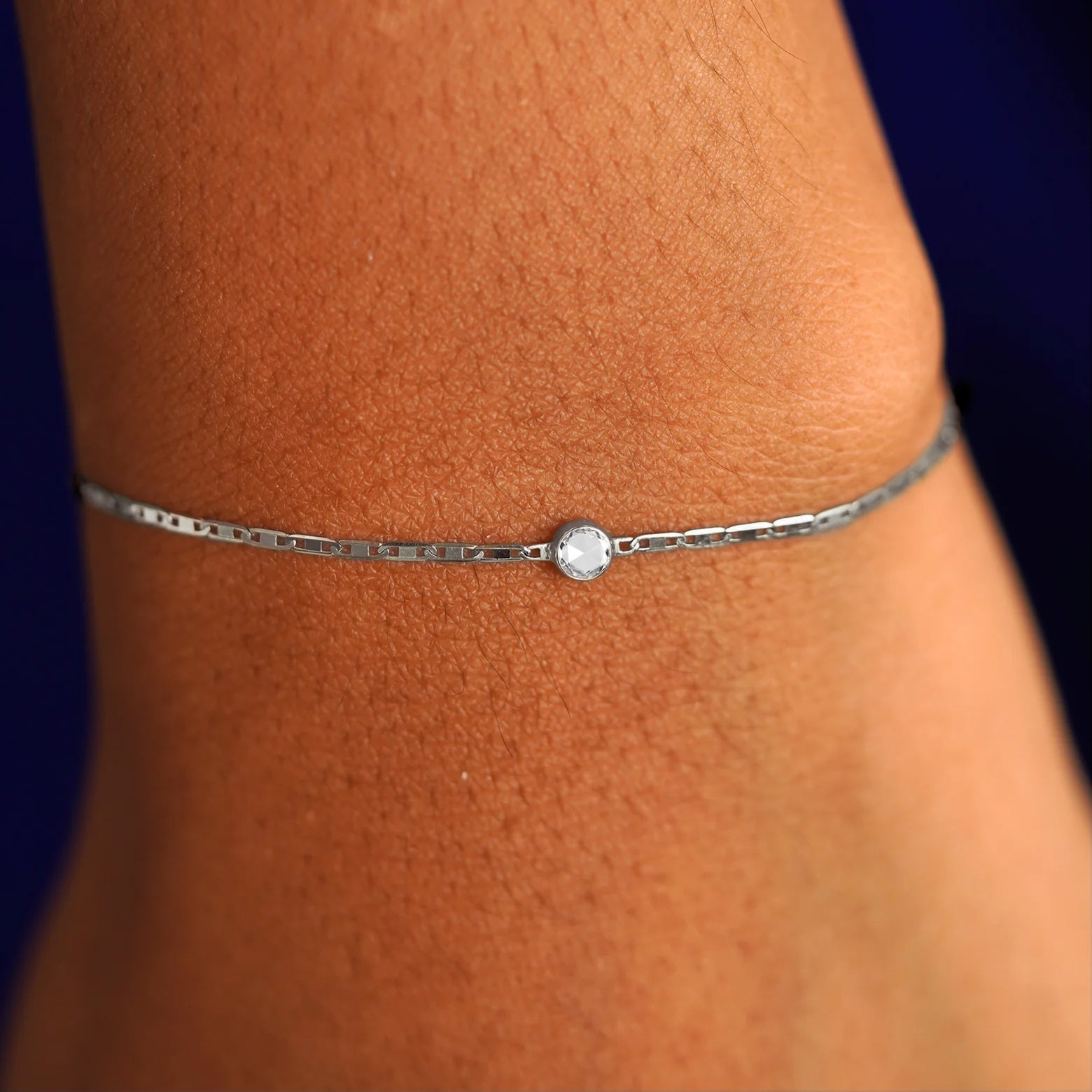 A model's wrist wearing a 14 karat white gold Rose Cut Diamond Bracelet