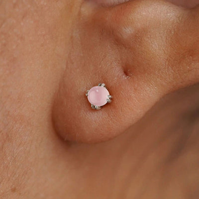 Close up view of a model's ear wearing a 14k white gold Rose Quartz Earring