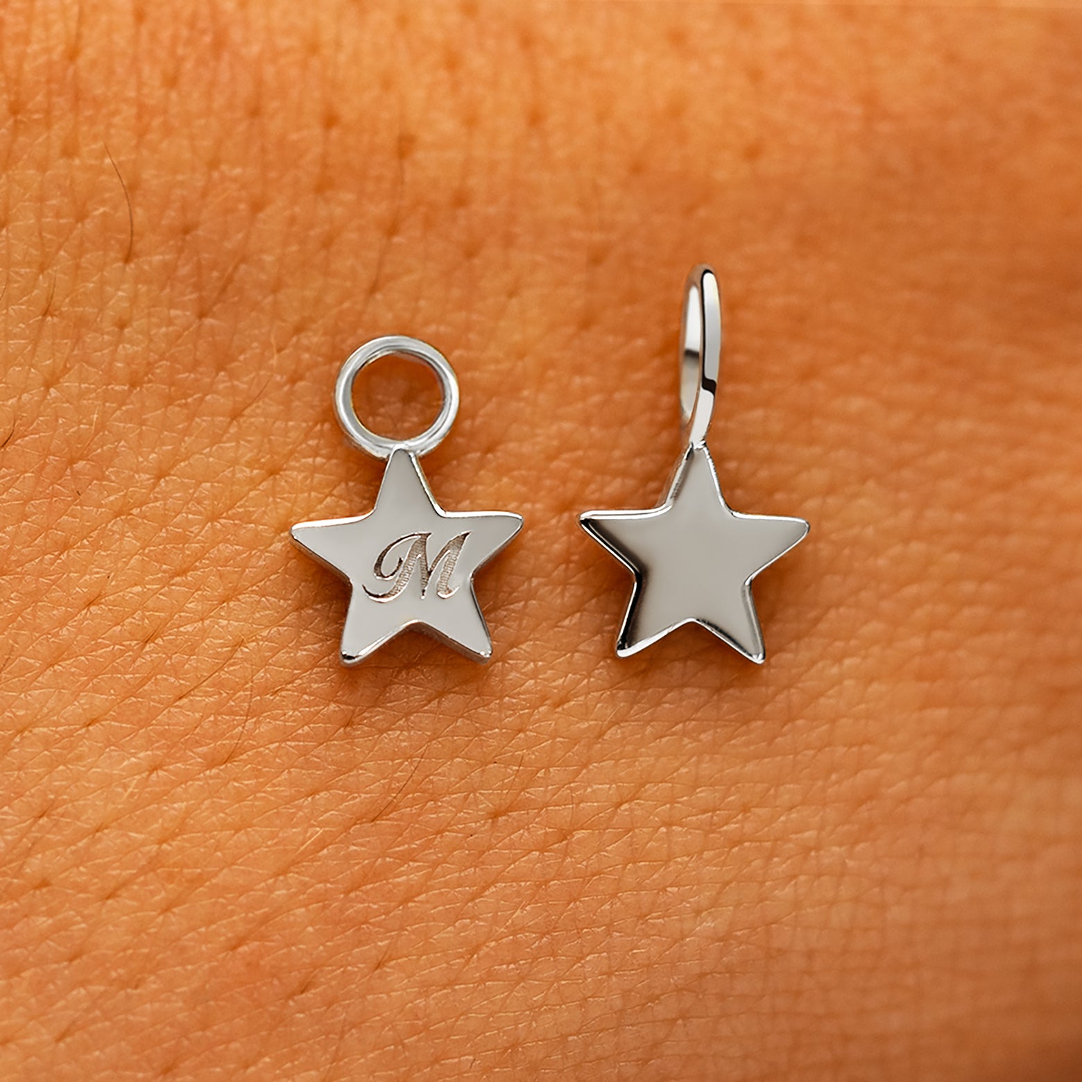 Two solid 14k white gold Star Charms showing the for chain and the for earring options
