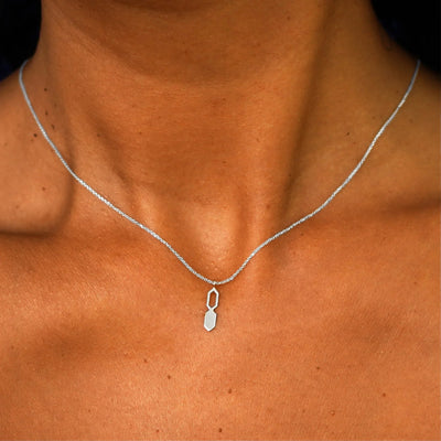Close up view of a model's neck wearing a solid 14k white gold Tanlah Cable Necklace