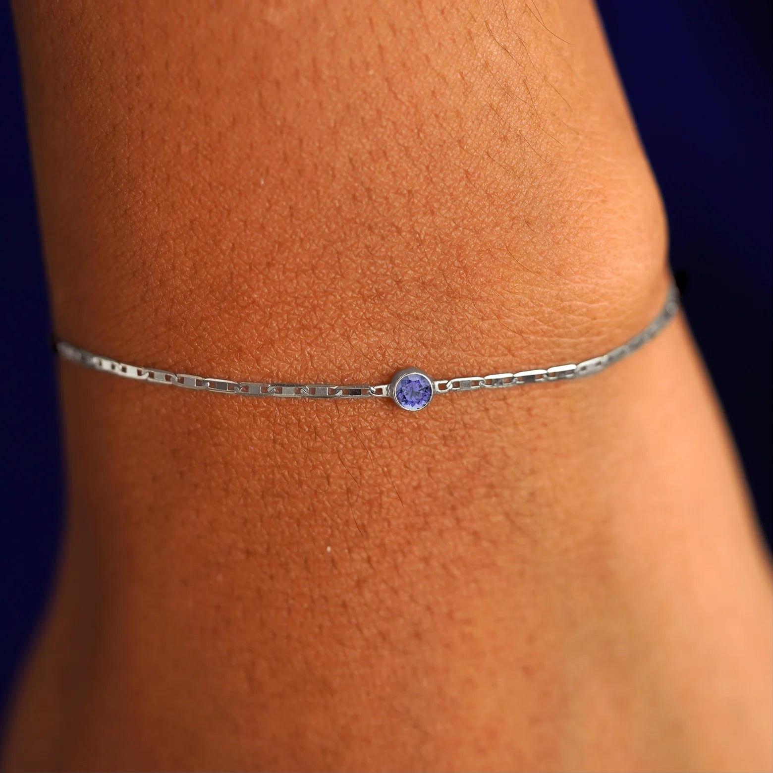 A model's wrist wearing a 14 karat white gold Tanzanite Bracelet