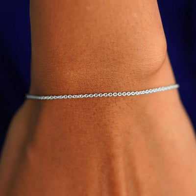 A model's wrist wearing a solid white gold Thick Cable Bracelet