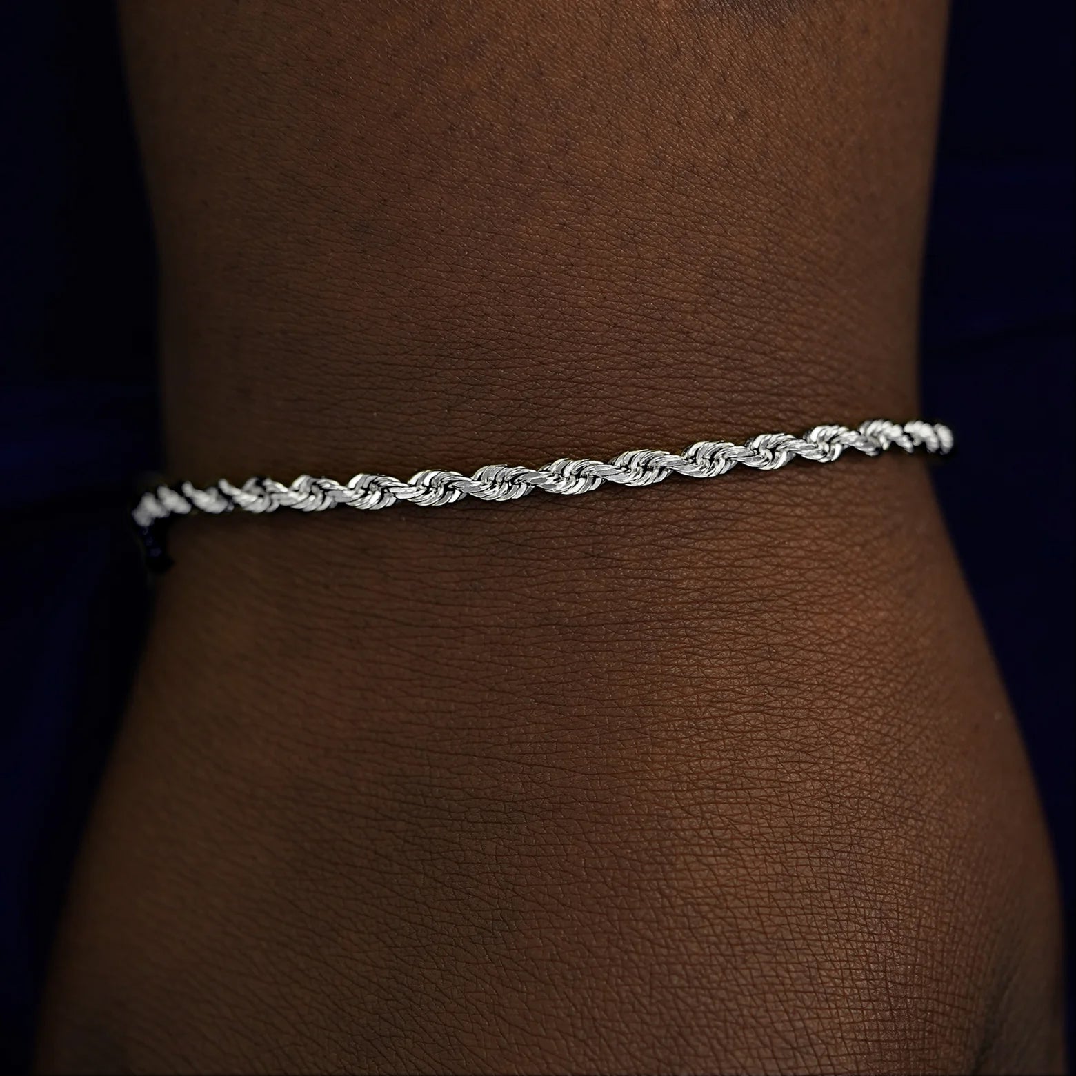 A model's wrist wearing a solid white gold Thick Rope Chain Bracelet