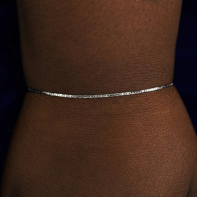 Close up view of a model's wrist wearing a white gold Valentine Bracelet