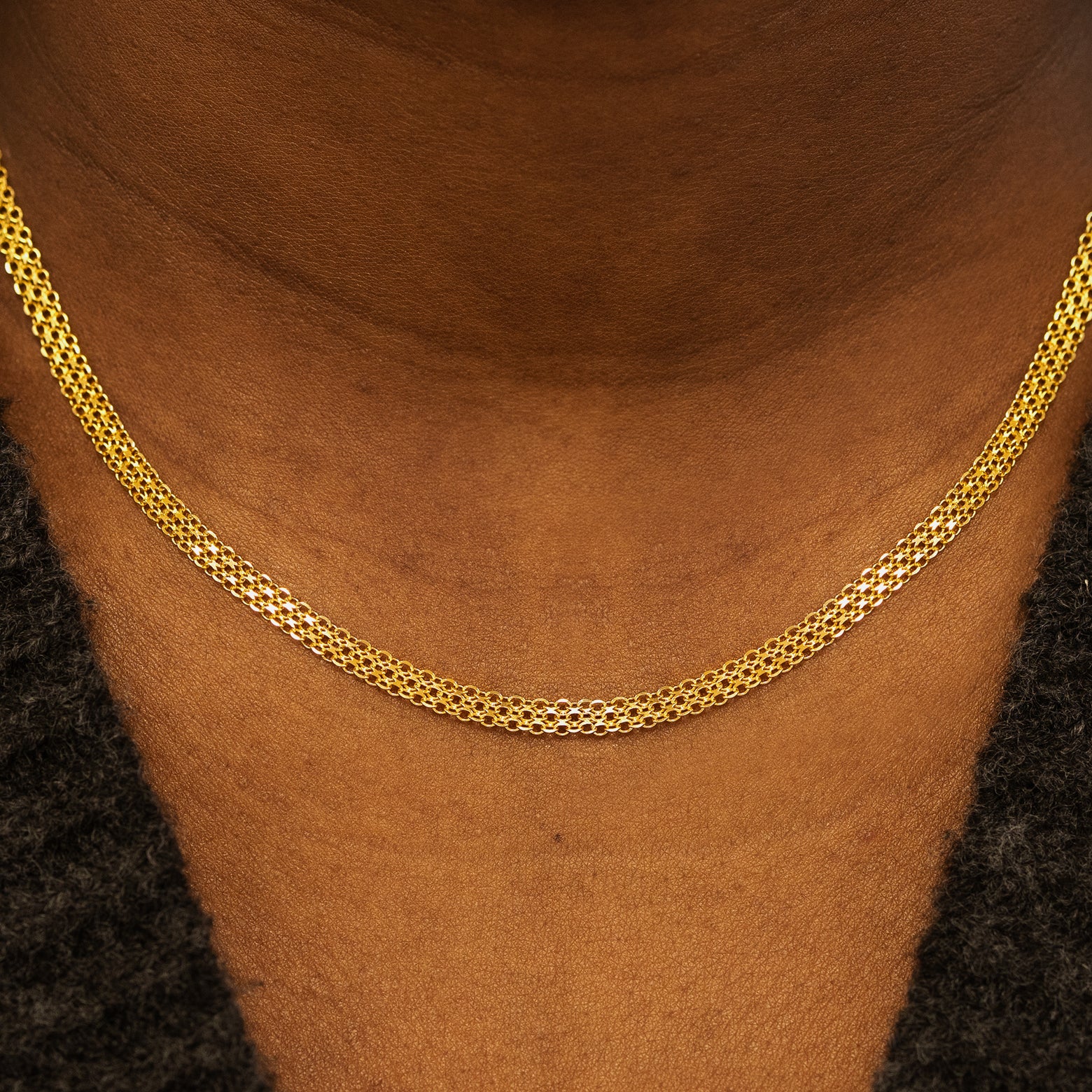 Close up view of a models neck wearing a solid 14k yellow gold Bismark Chain Necklace