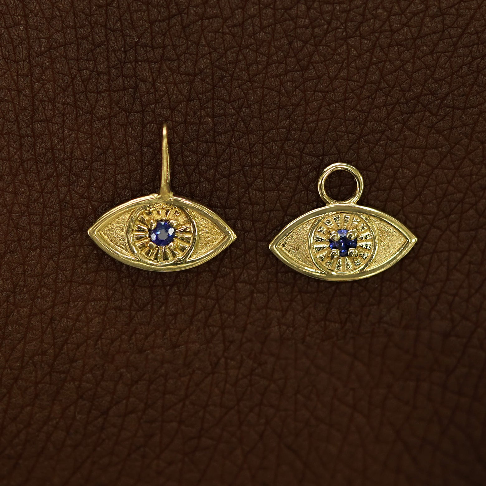 Two 14 karat Yellow gold blue sapphire Evil Eye Charms shown in the For Chain and For Earring options
