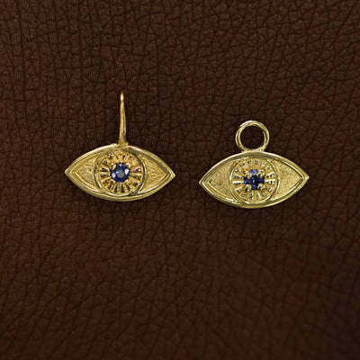 Two 14 karat Yellow gold blue sapphire Evil Eye Charms shown in the For Chain and For Earring options
