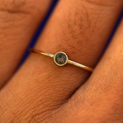 Close up view of a model's fingers wearing a 14k yellow gold Smoky Quartz Ring