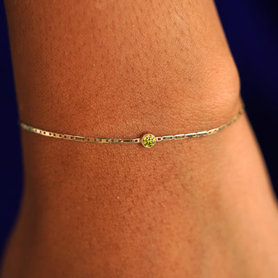 A model's wrist wearing a 14 karat yellow gold Yellow Diamond Bracelet